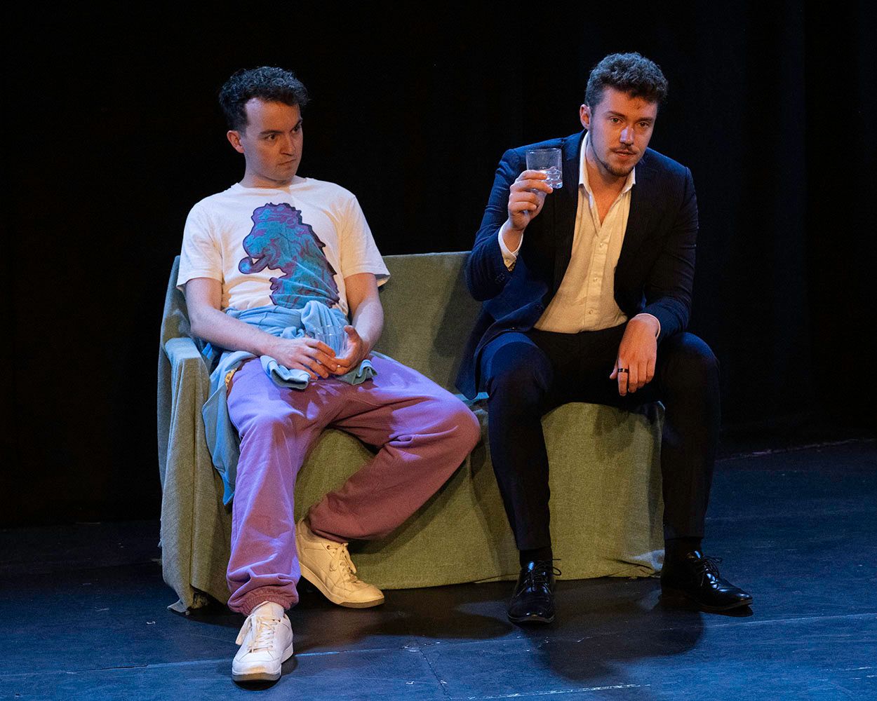 Theatre Review: Olly and Aaron sit on the sofa in Love is Blue